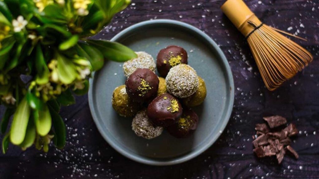 An overhead view looking down onto a gray plate holding several Matcha Energy Balls.