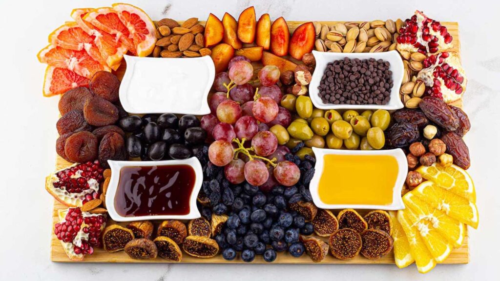 An overhead view of a full mezze platter with healthy dessert snacks.