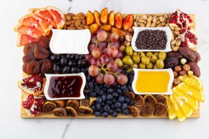 A horizontal, overhead view of a Dessert Mezze Platter on a white, marble surface.