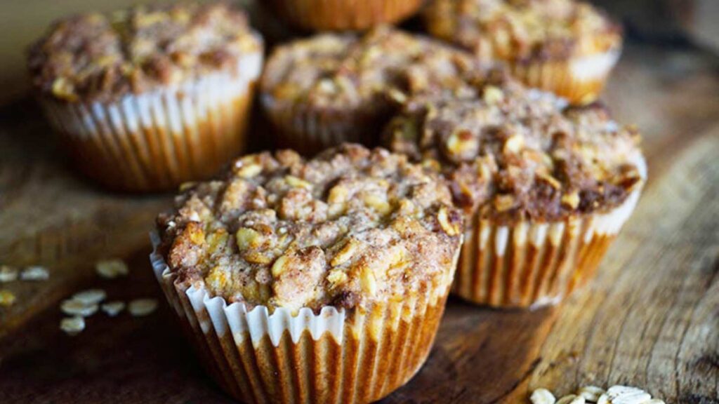The finished Oat Flour Muffins With Streusel Topping, sitting on a cutting board.