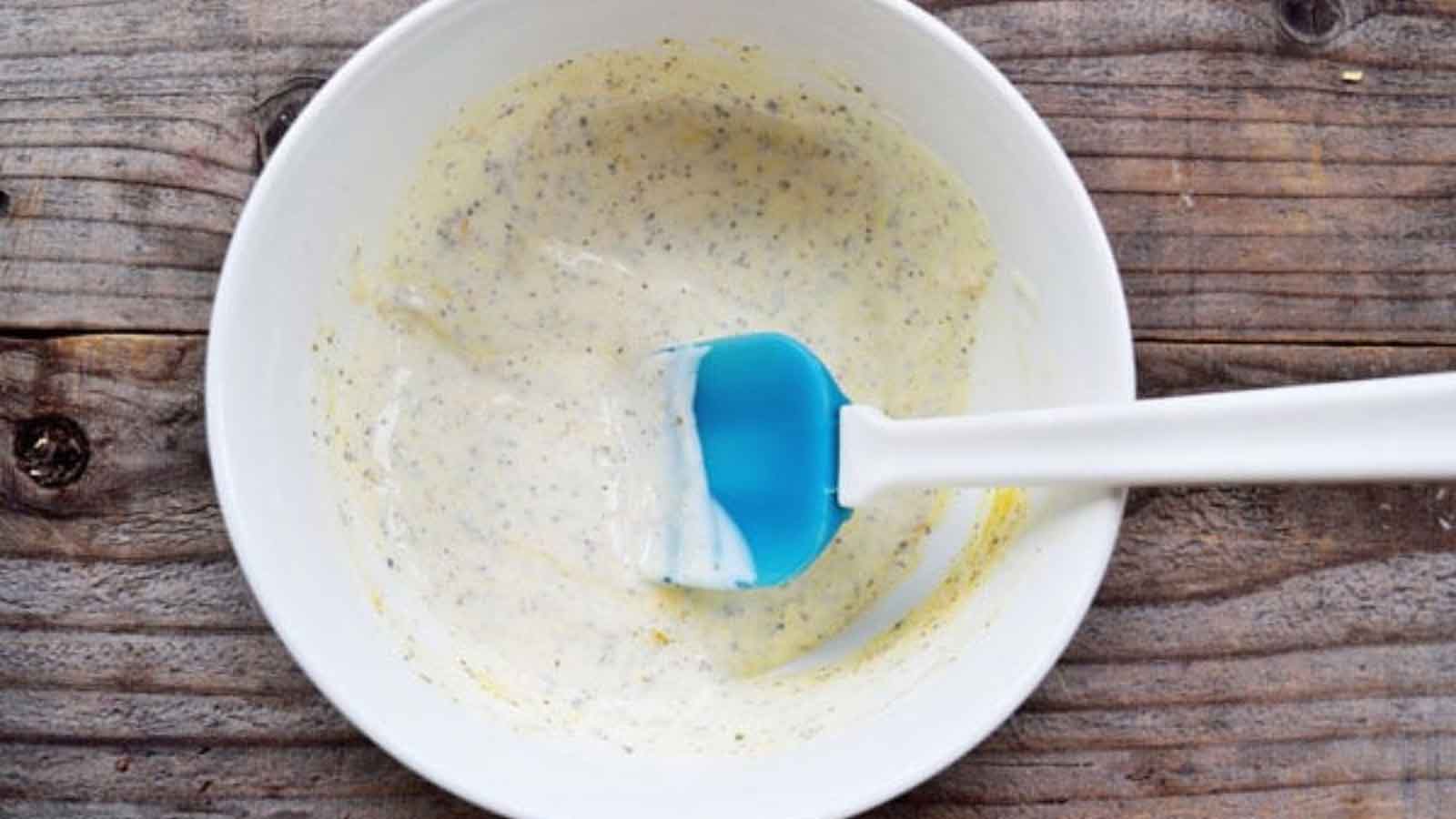 Onion Dip in a white bowl with a spatula resting in it.