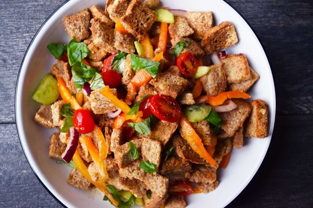 Panzanella served in a white bowl.