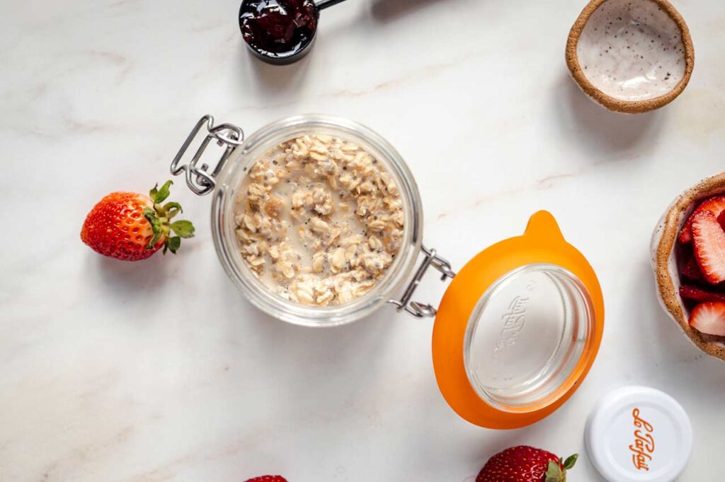 Mixed overnight oats in a canning jar with the lid open.