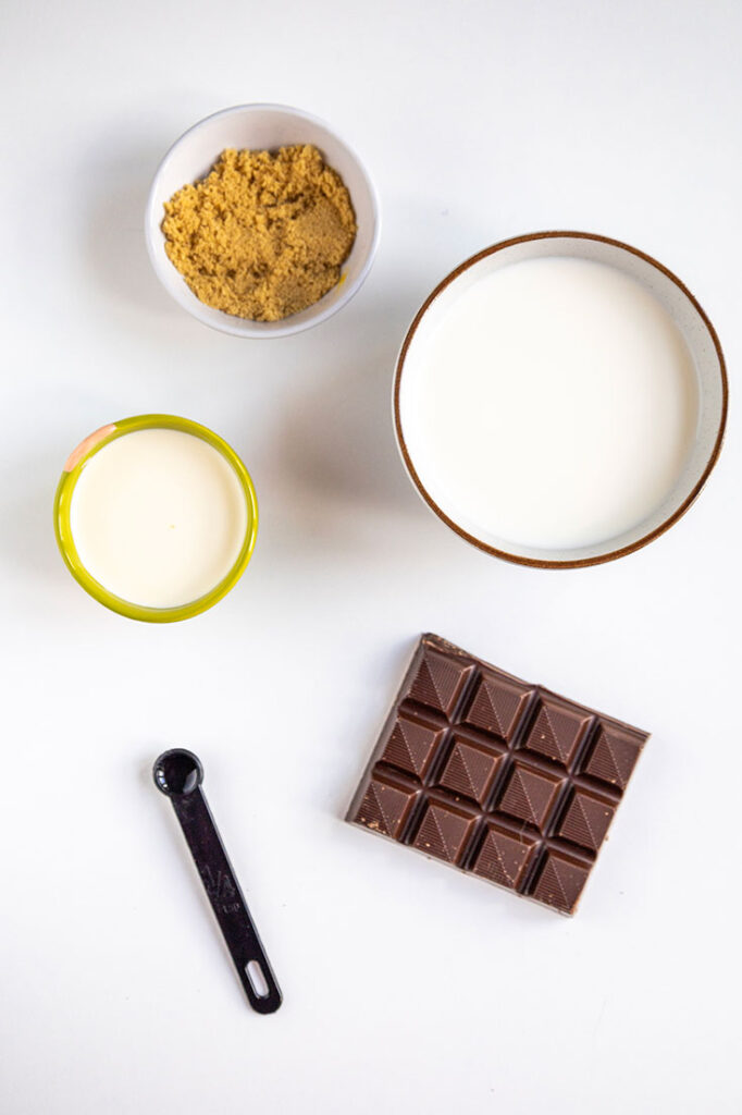 Ingredients for Peppermint Hot Chocolate sitting in individual bowls on a white background.