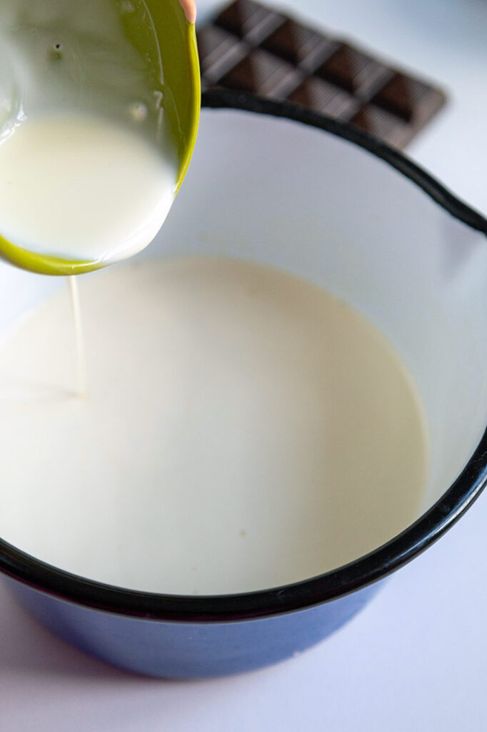 Pouring milk into a pot.
