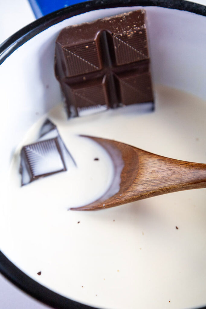 Melting chocolate in milk in a small pot.