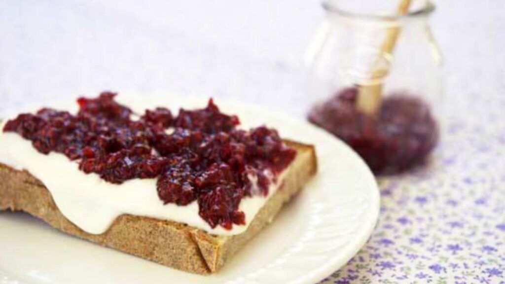 A slice of toast with Raspberry Butter on it.