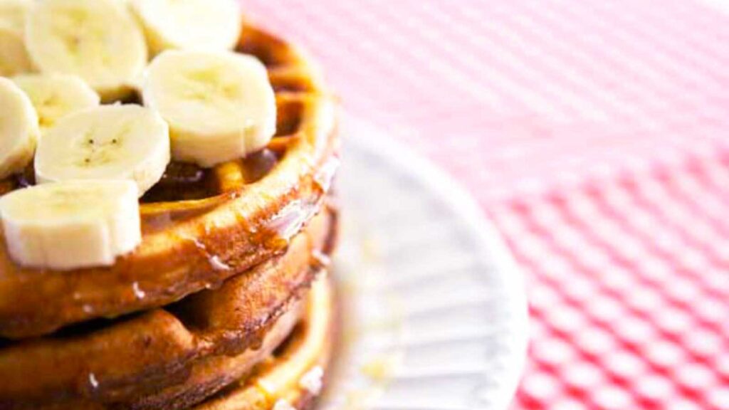 A stack of Saturday Morning Waffles on a white plate.