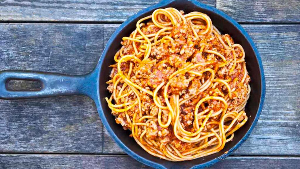 An overhead view looking down into a cast iron skillet filled with this Skillet Spaghetti Recipe.