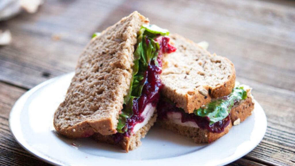 Traditional Leftover Turkey Sandwich on a white plate.