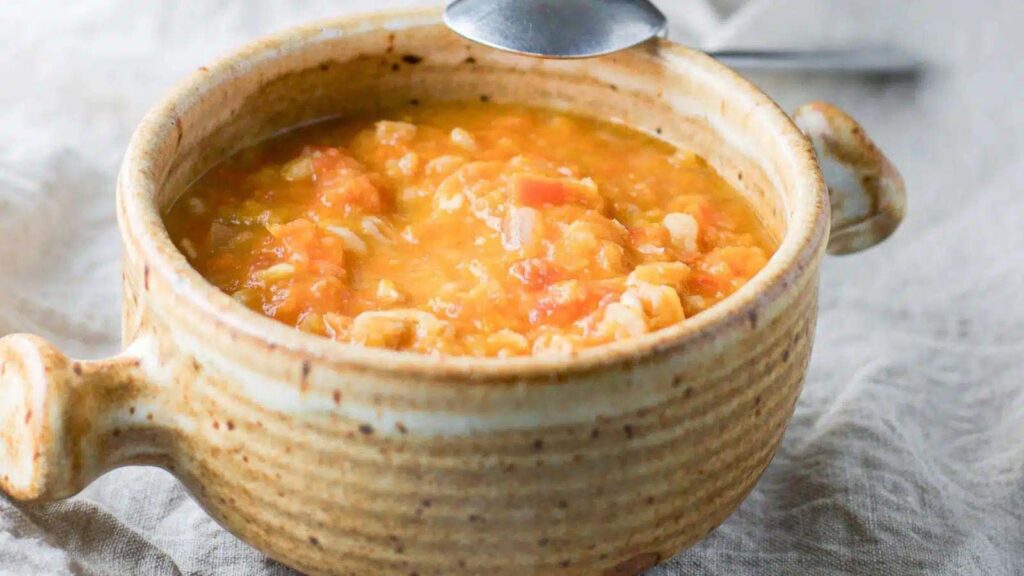A crock filled with Tuscan white bean soup.