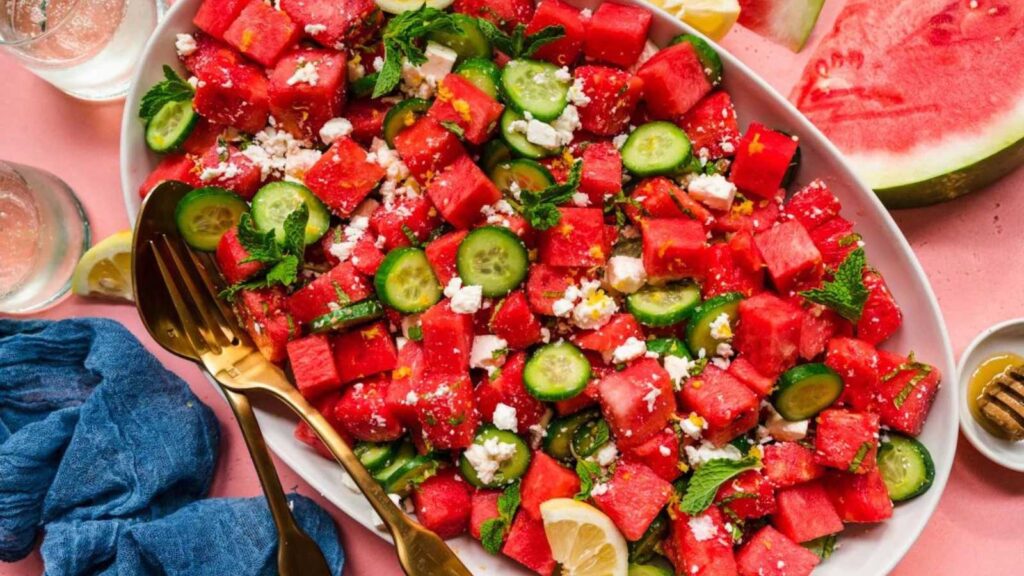 A platter filled with watermelon feta cucumber salad.