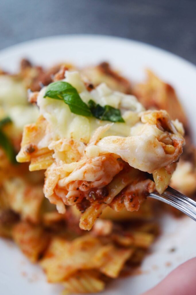 A fork holds up a bit of baked ziti.