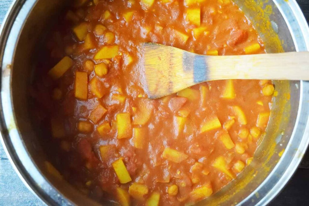 Cooked Bombay Potatoes in a large pot.