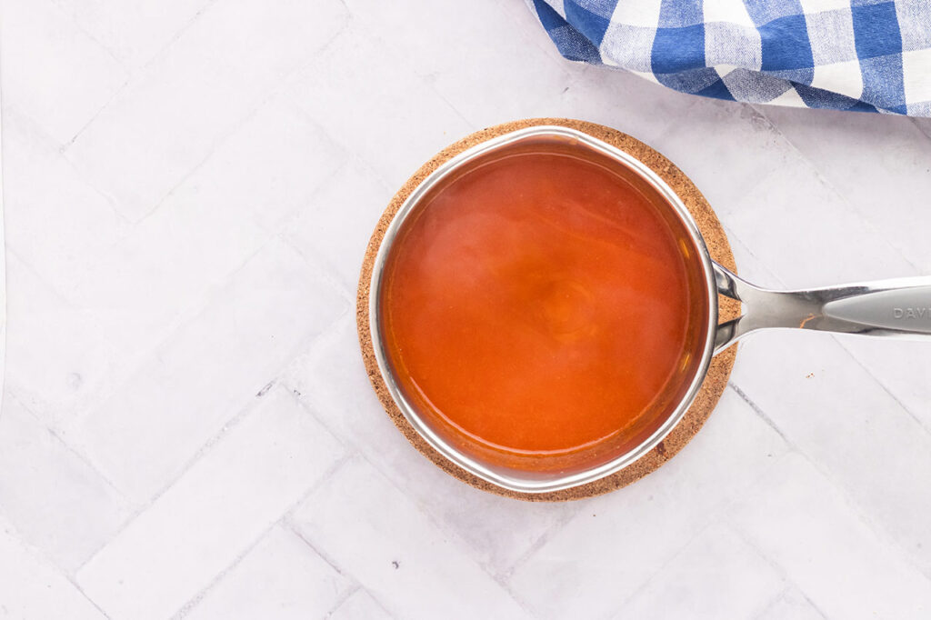 Wing sauce in a pot, cooling.