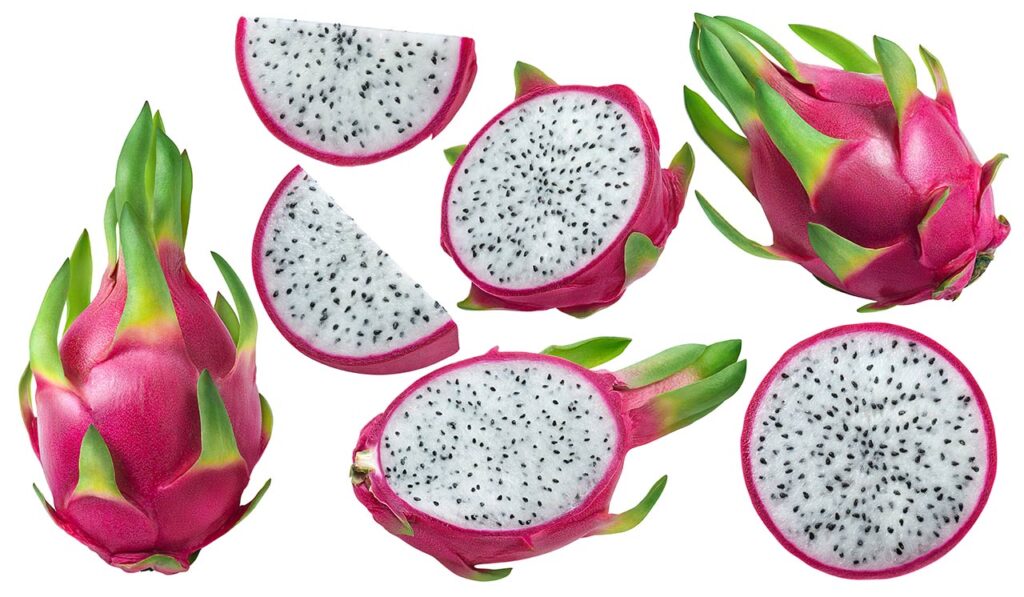 Several dragon fruits on a white background. Some are cut into pieces.