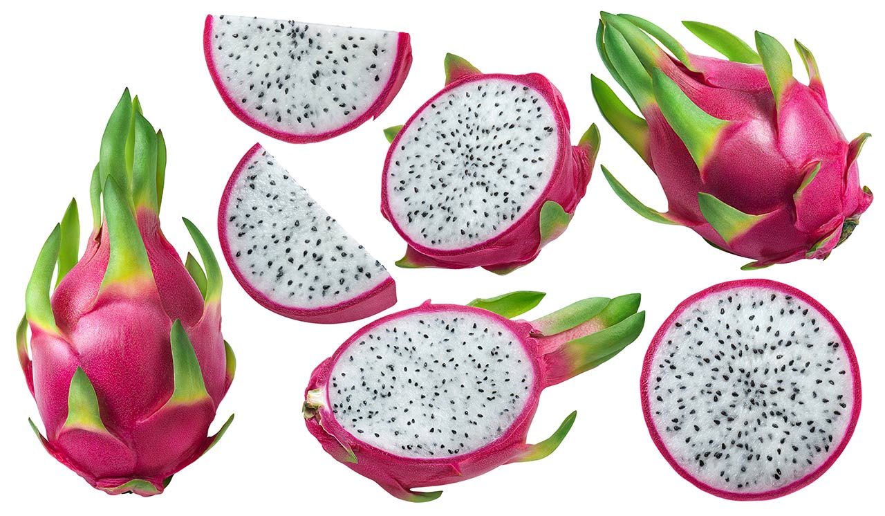 Several dragon fruits on a white background. Some are cut into pieces.