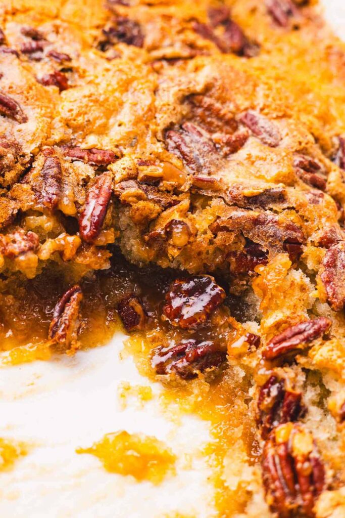 A slice of pecan cobbler removed from the baking dish.