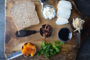Mediterranean Sandwich Recipe ingredients gathered on a cutting board.
