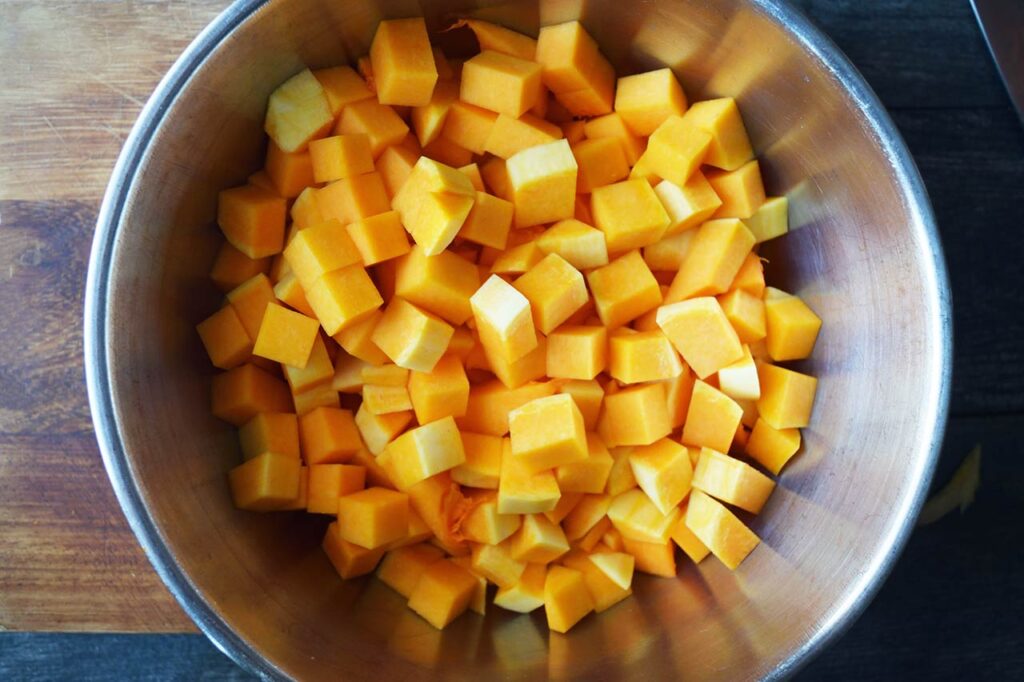 Butternut squash cubes in a large mixing bowl.