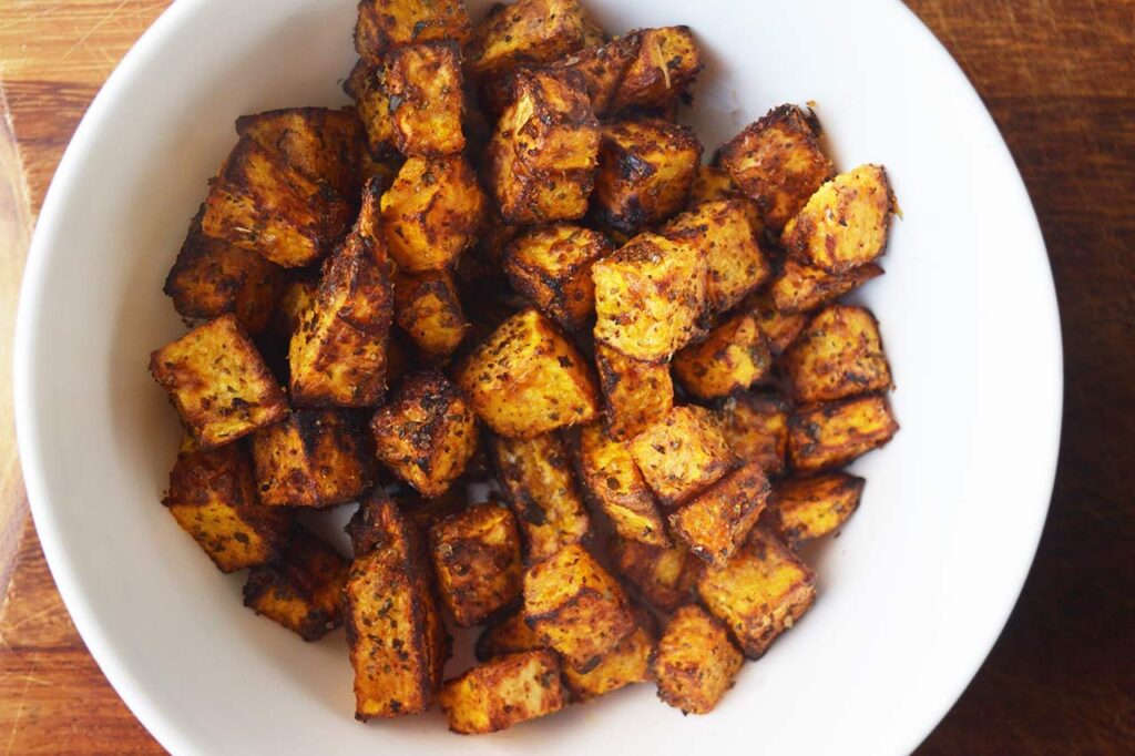 Air fryed Roasted Butternut Squash in a white bowl.