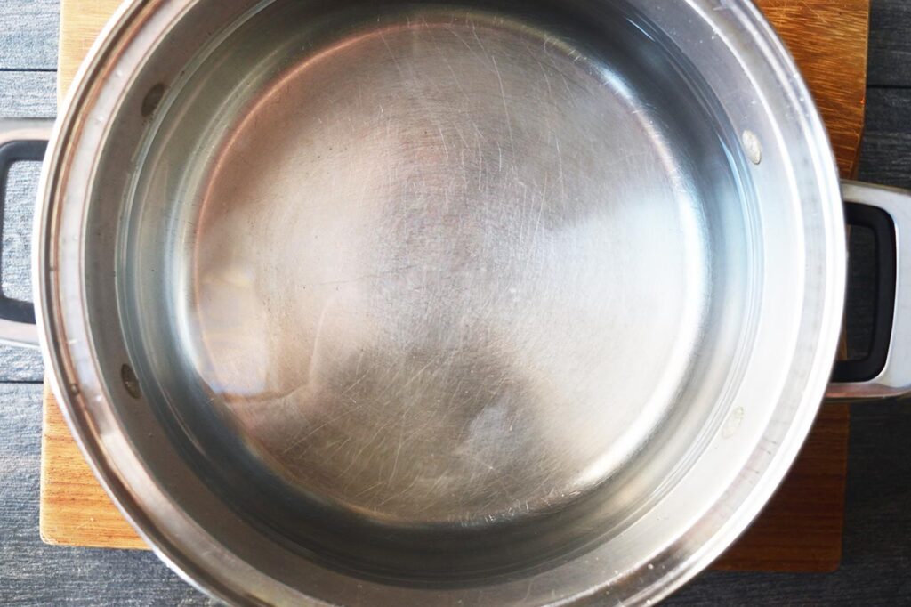 An overhead view of a large pot filled with water.