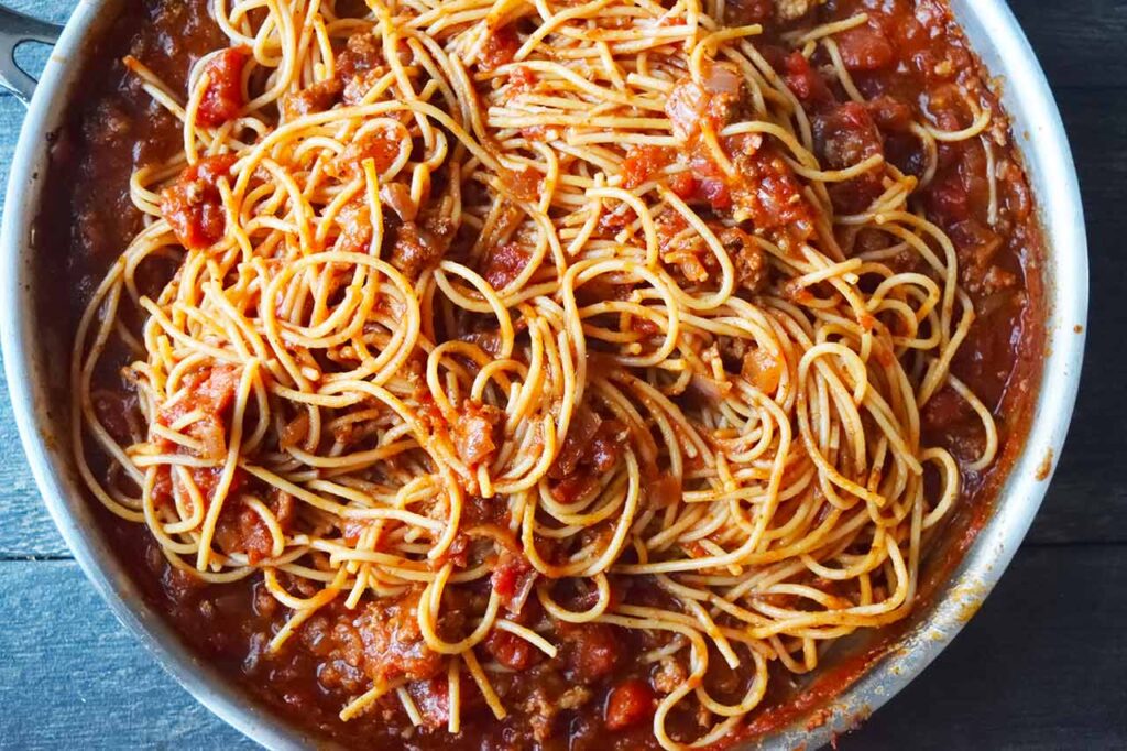 The finished spaghetti recipe in a skillet.