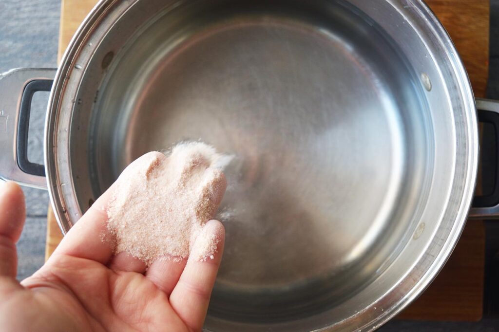 Adding salt to pasta water.