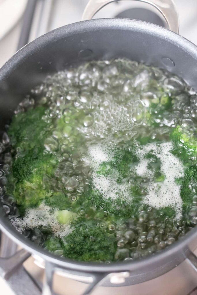Broccoli boiling in a pot.
