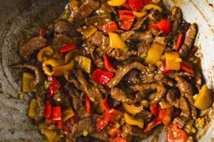 An overhead view of Kung Pao Beef in a wok.