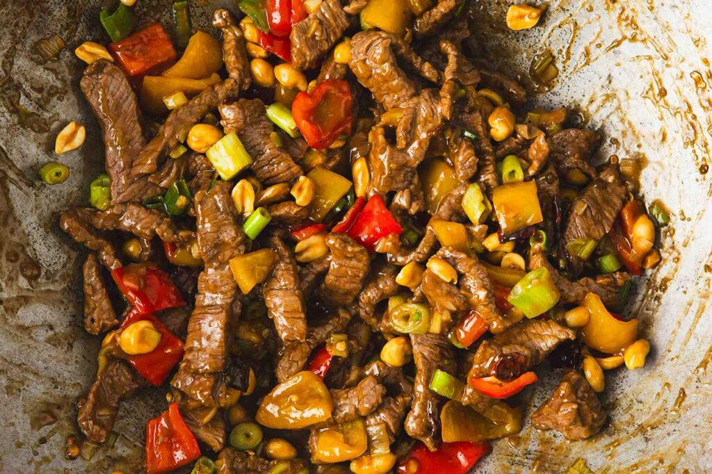 Kung Pao Beef with peanut added in a wok.