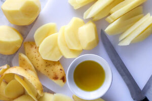 Cutting fries on a white cutting board.