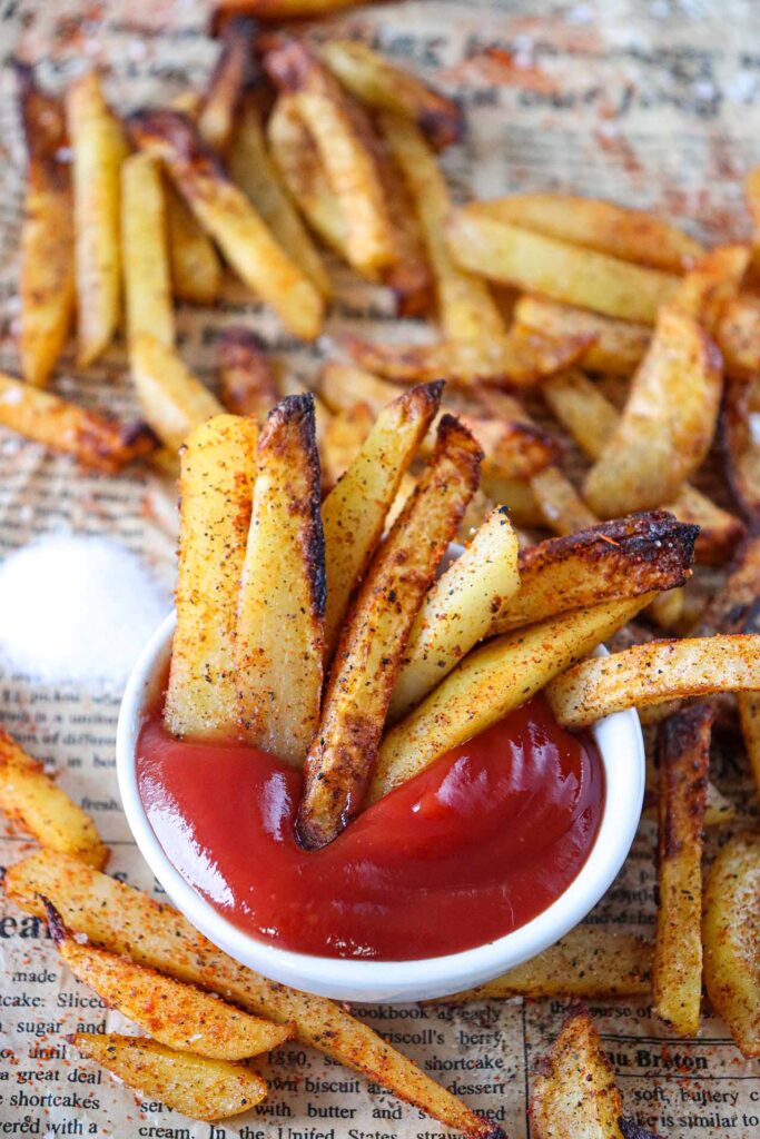 Fries stuffed into a bowl of ketchup.