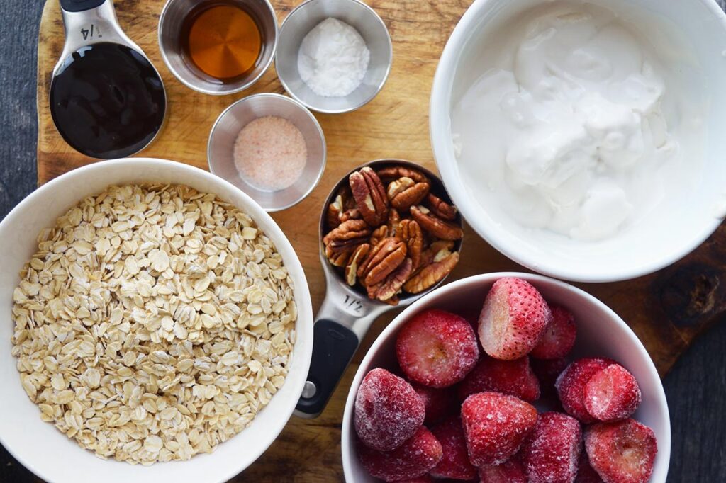 Baked Oatmeal With Strawberries Recipe ingredients in individual bowls.