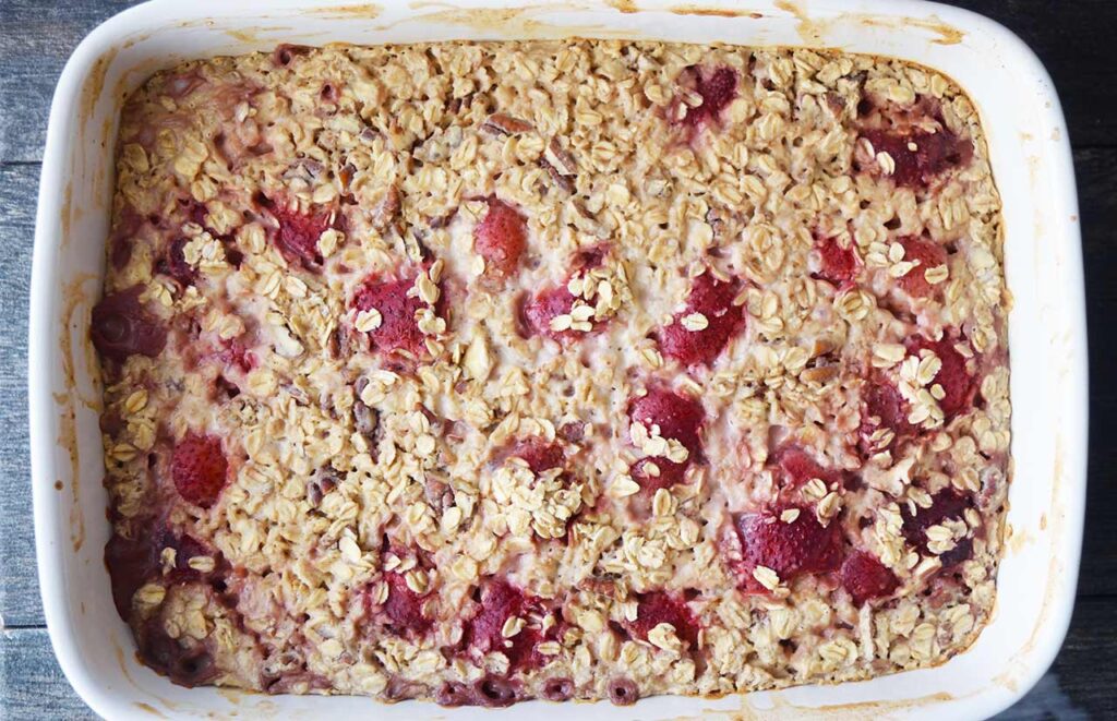 Just baked Oatmeal With Strawberries in a white casserole dish.