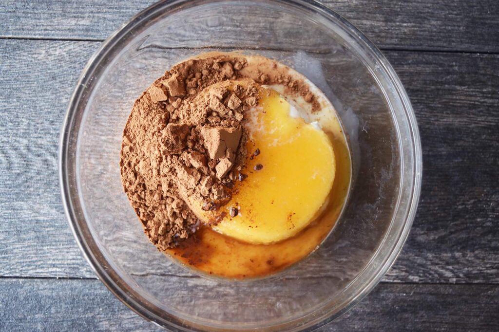 Brownie batter dip ingredients in a glass mixing bowl.