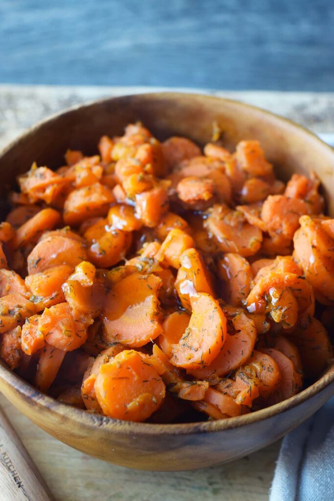 A wood bowl full of dill carrots.
