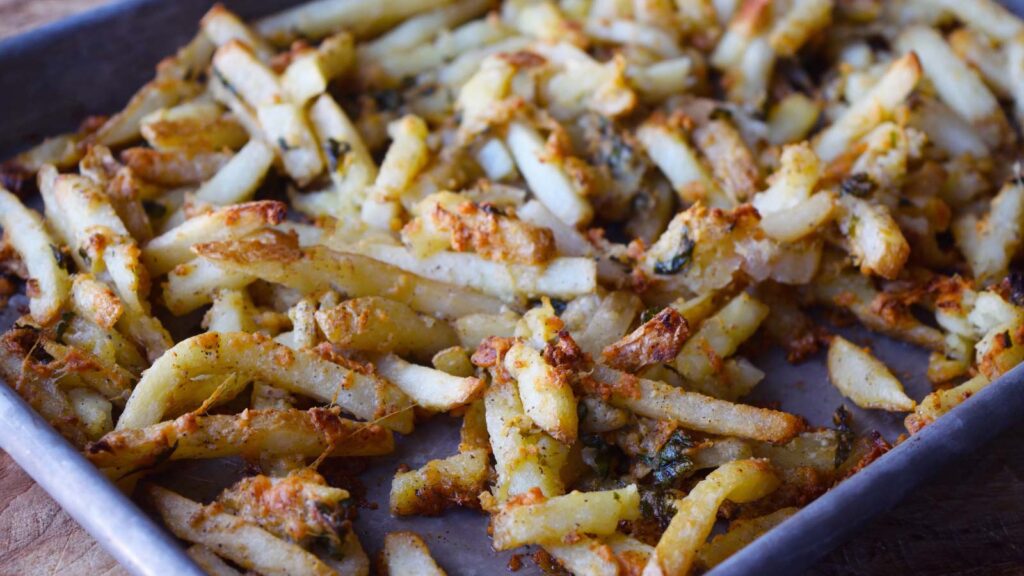 Baked garlic fries on a baking sheet.