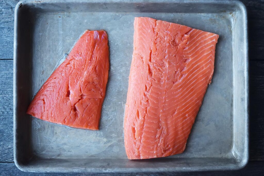 Salmon fillets on a baking pan.