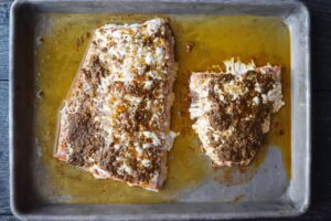 Baked salmon fillets on a baking sheet.