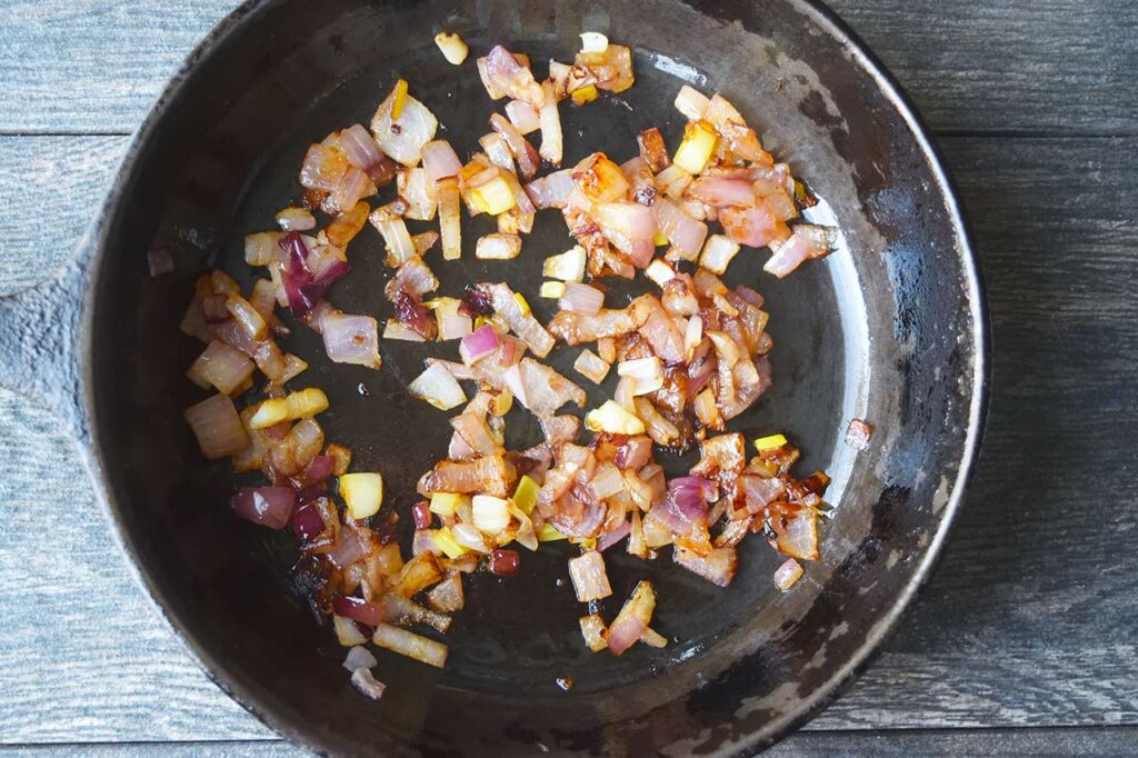 Caramelized onions in a black skillet.