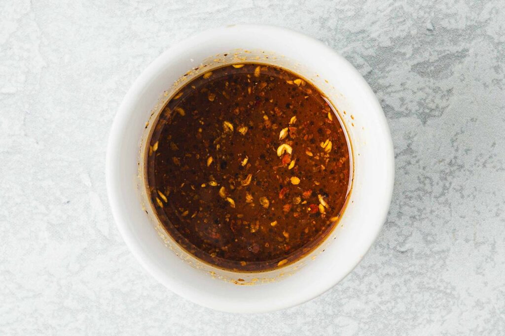 Kung Pao Beef sauce in a white bowl.