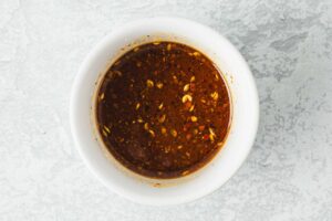 Kung Pao Beef sauce in a white bowl.