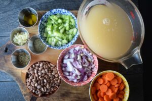 Pinto Bean Soup Recipe ingredients gathered on a wood cutting board.