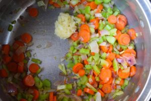 Sautéd veggies with minced garlic added, in a large soup pot.