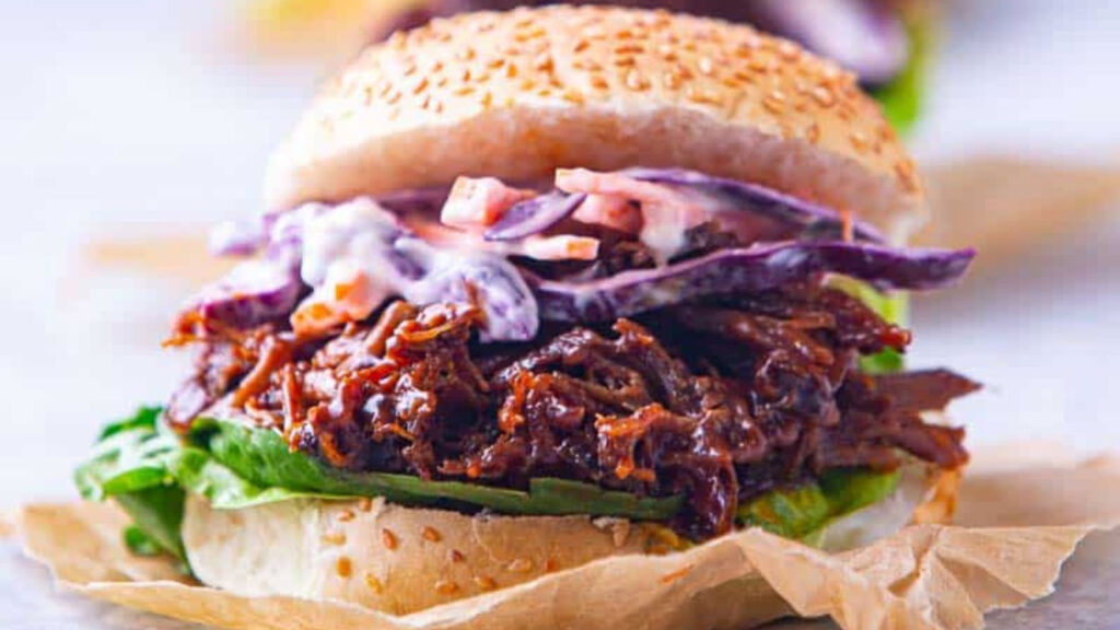 A closeup of a bbq pulled lamb sandwich.