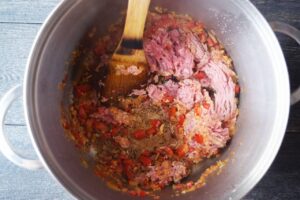 Browning meat in a soup pot with sautéd onions and bell peppers.