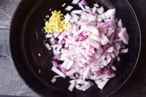 Onions and ginger in a skillet.