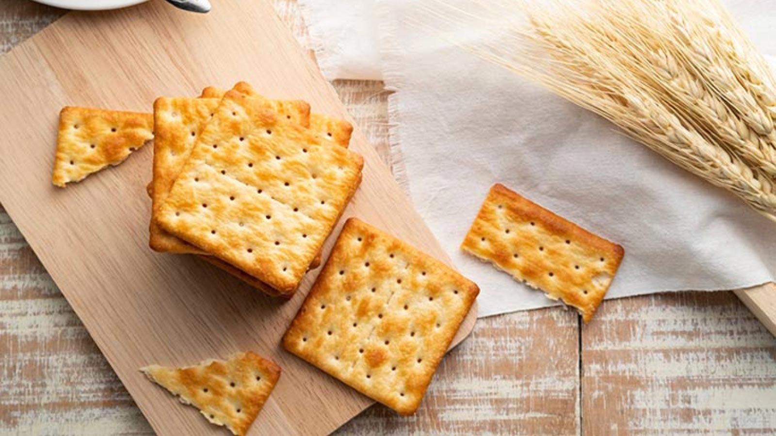 A stack of crackers on a cutting board.