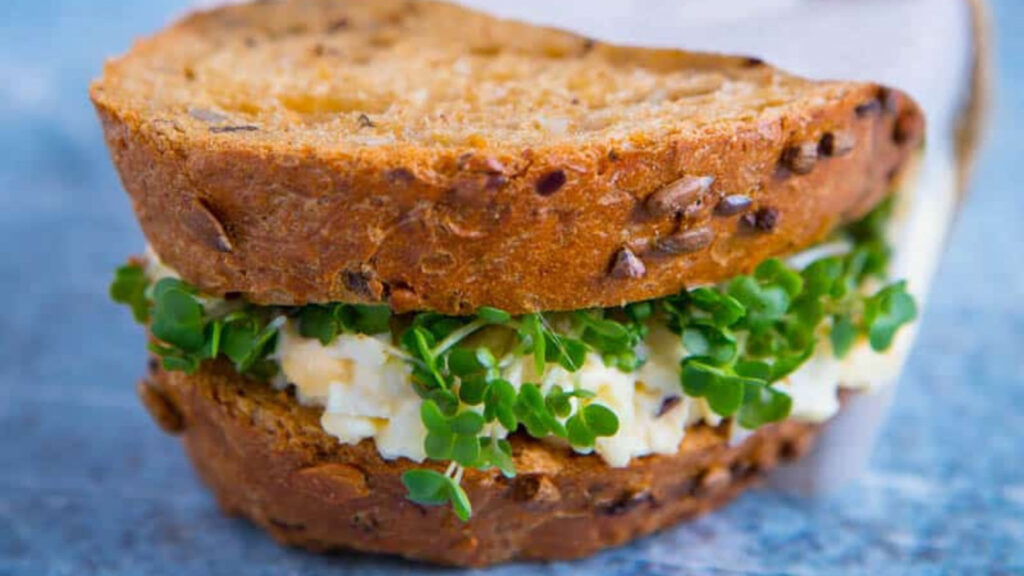 A closeup of an egg and mayo sandwich.